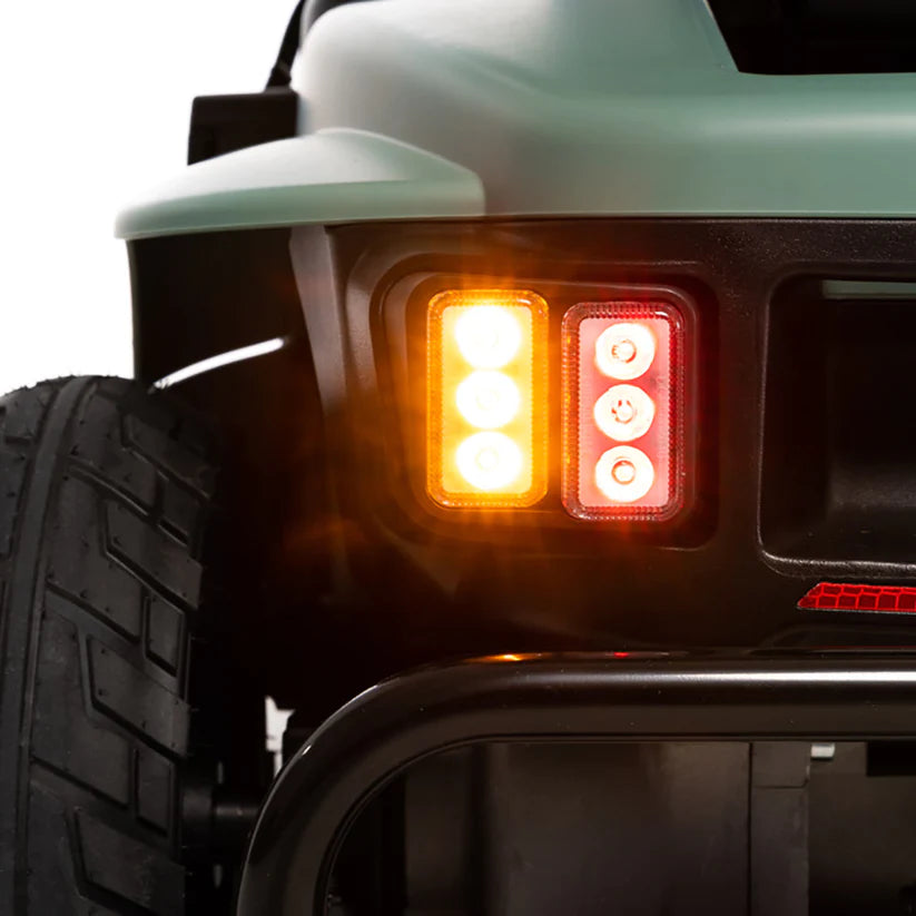 Close-up of Pride Baja Bandit rear lights and tire showing brake and indicator lights