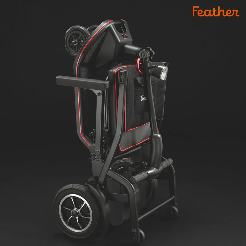 Folded Feather Scooter in black with red accents showing compact design and sturdy wheels