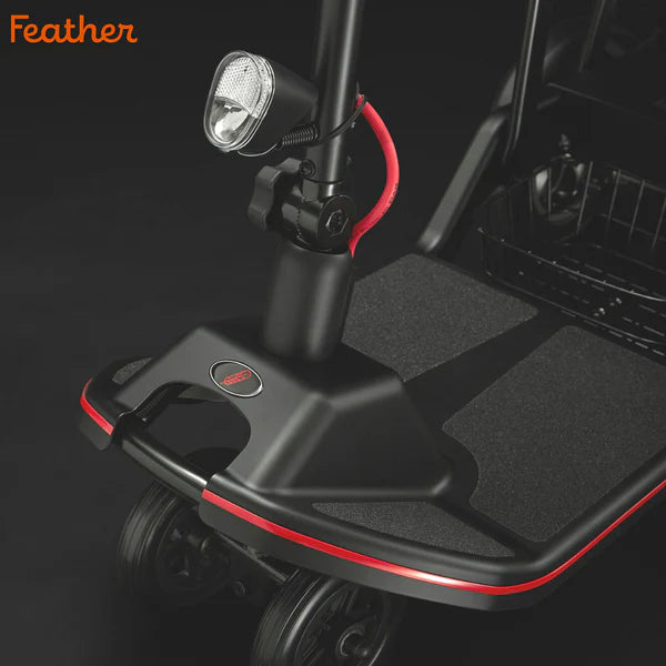 Close-up of Feather Scooter front platform and headlight with black and red accents