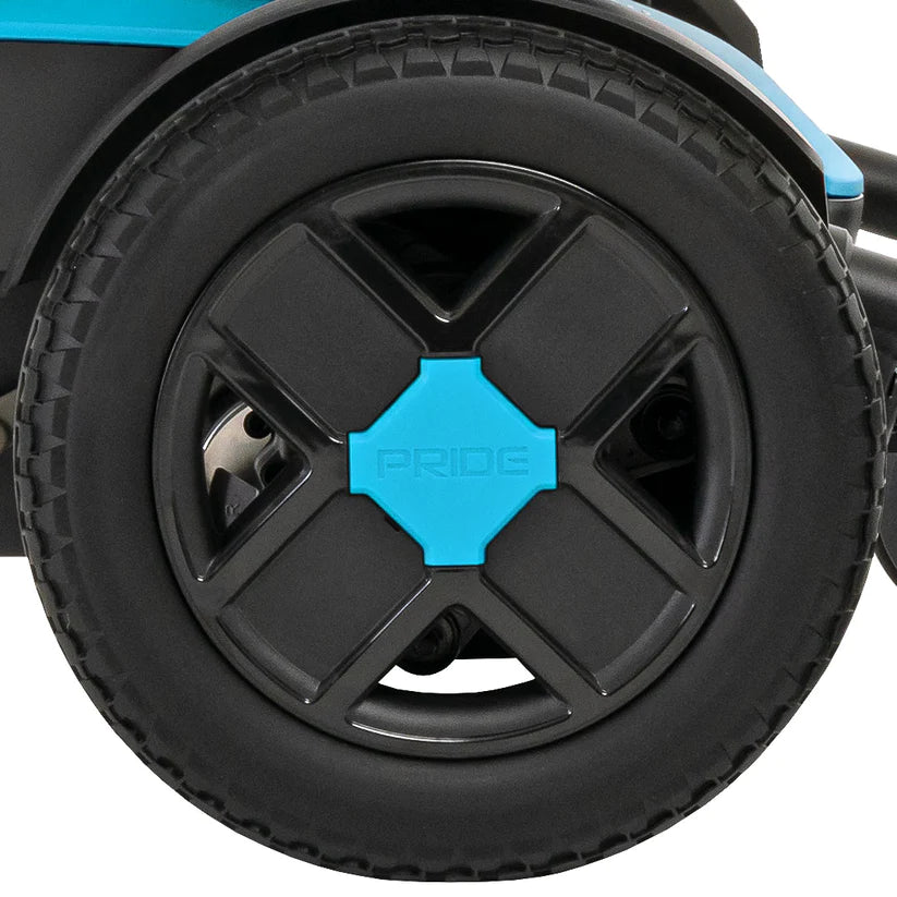 Close-up of black and blue wheel of Pride Jazzy EVO 613 Power Chair showing tire and hubcap details