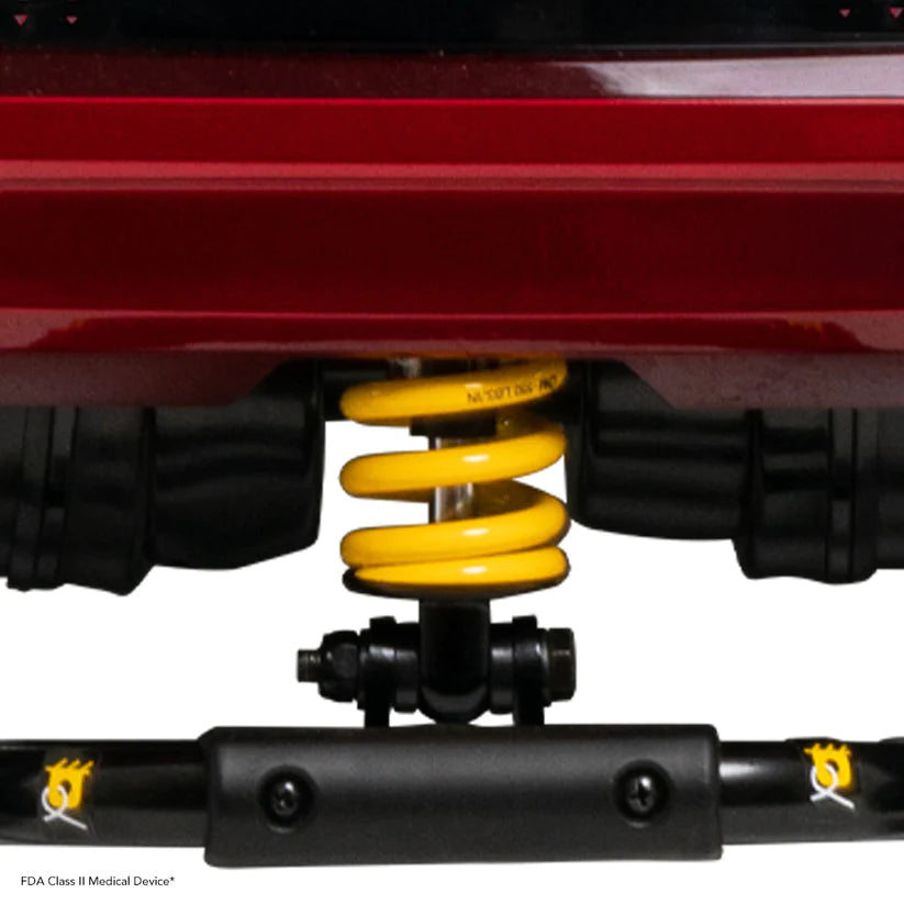 Close-up of suspension spring on Pride Zero Turn 10 Mobility Scooters showing yellow coil and black support structure