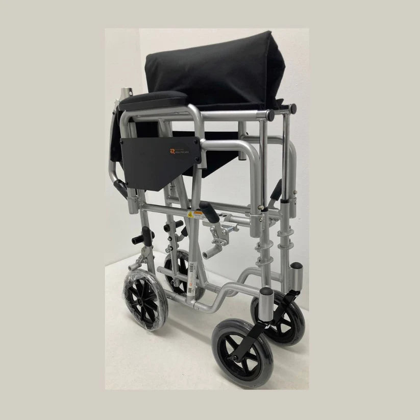 Folded Rhythm Combo Wheelchair with black padded seat and silver frame for easy transport