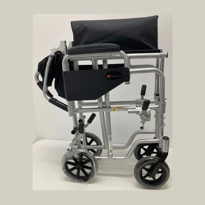 Folded Rhythm Combo Wheelchair by Rhythm Healthcare with black seat and silver frame for easy transport