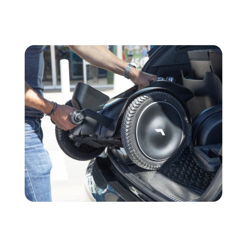 Person loading the WHILL Model C2 Smart Power Chair into a car trunk for easy transport