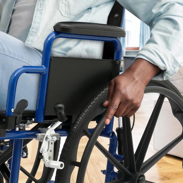 Close-up of a person using the Ziggo Pro Reclining Wheelchair with blue frame and black cushioned armrest