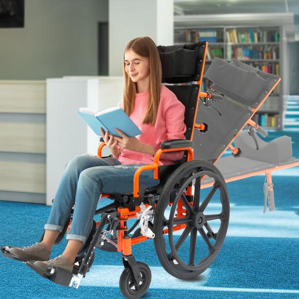 Young woman sitting and reading a book in an orange and black Ziggo Pro Reclining Wheelchair indoors